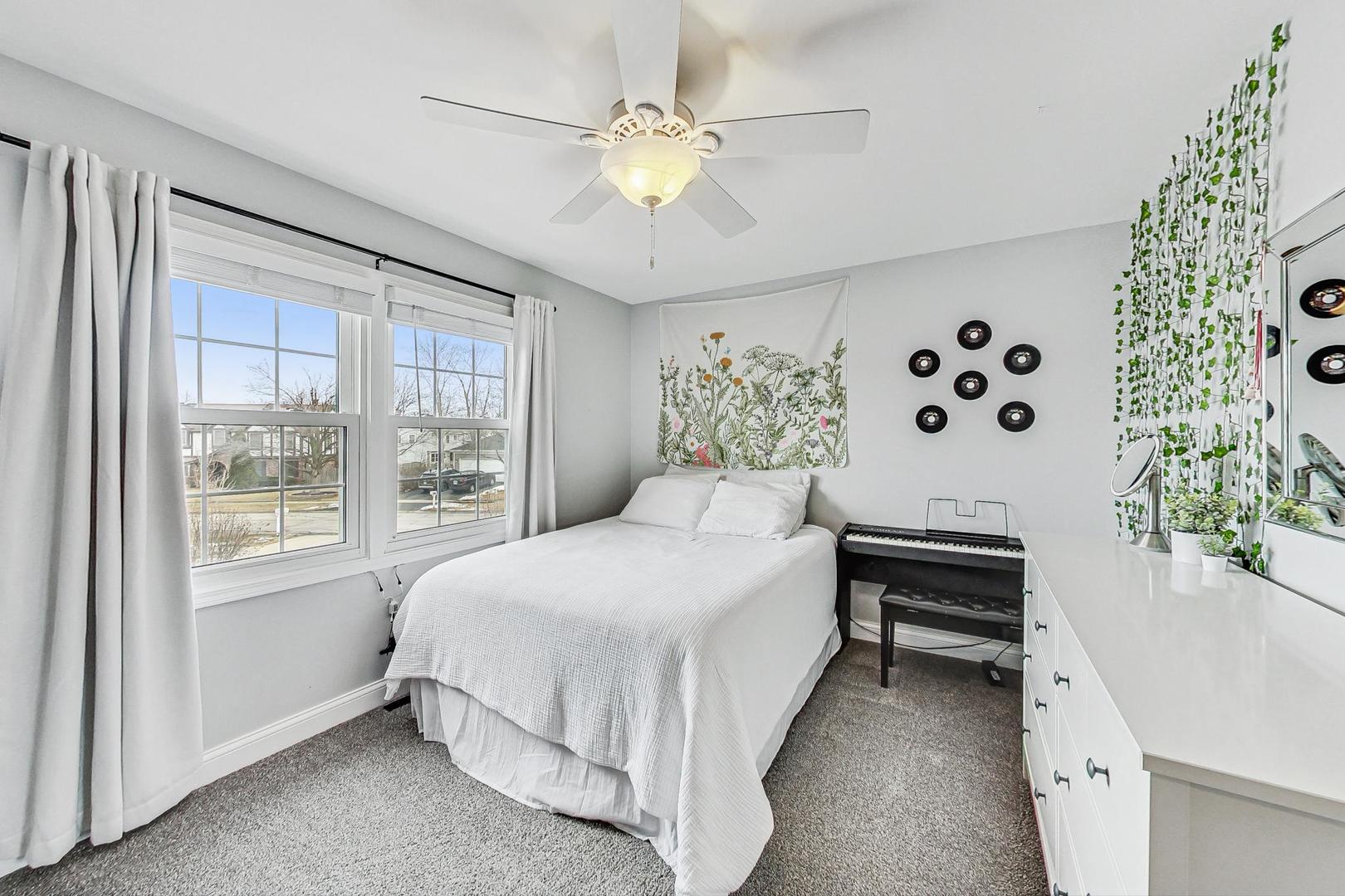 1345 East Bailey Road Naperville, IL 60565 - Photo 23 of 49 a bedroom with a large bed and a chandelier