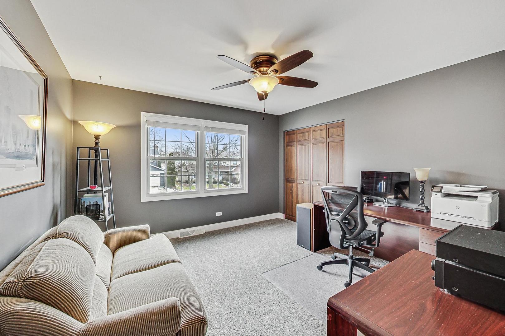 1345 East Bailey Road Naperville, IL 60565 - Photo 25 of 49 a living room with furniture a window and a flat screen tv