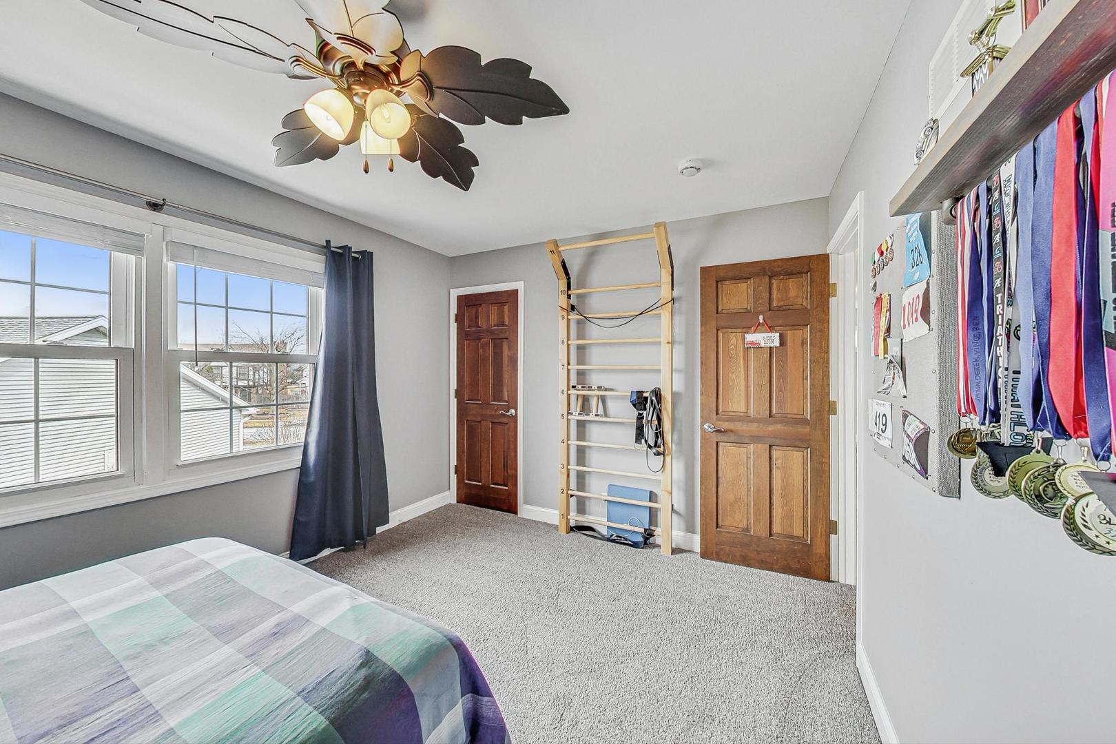 1345 East Bailey Road Naperville, IL 60565 - Photo 28 of 49 a bedroom with chandelier fan and windows