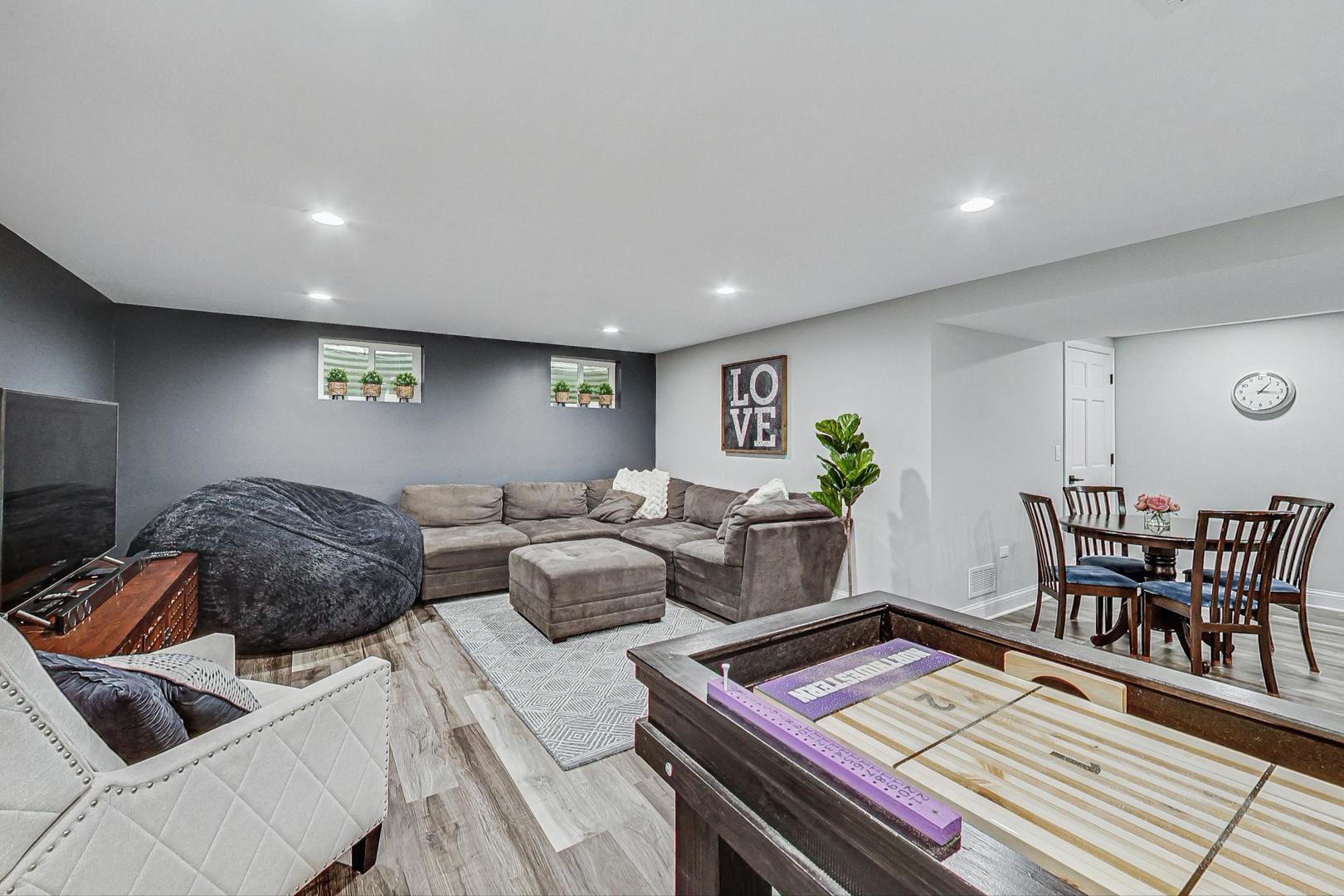 1345 East Bailey Road Naperville, IL 60565 - Photo 32 of 49 a living room with furniture and a wooden floor
