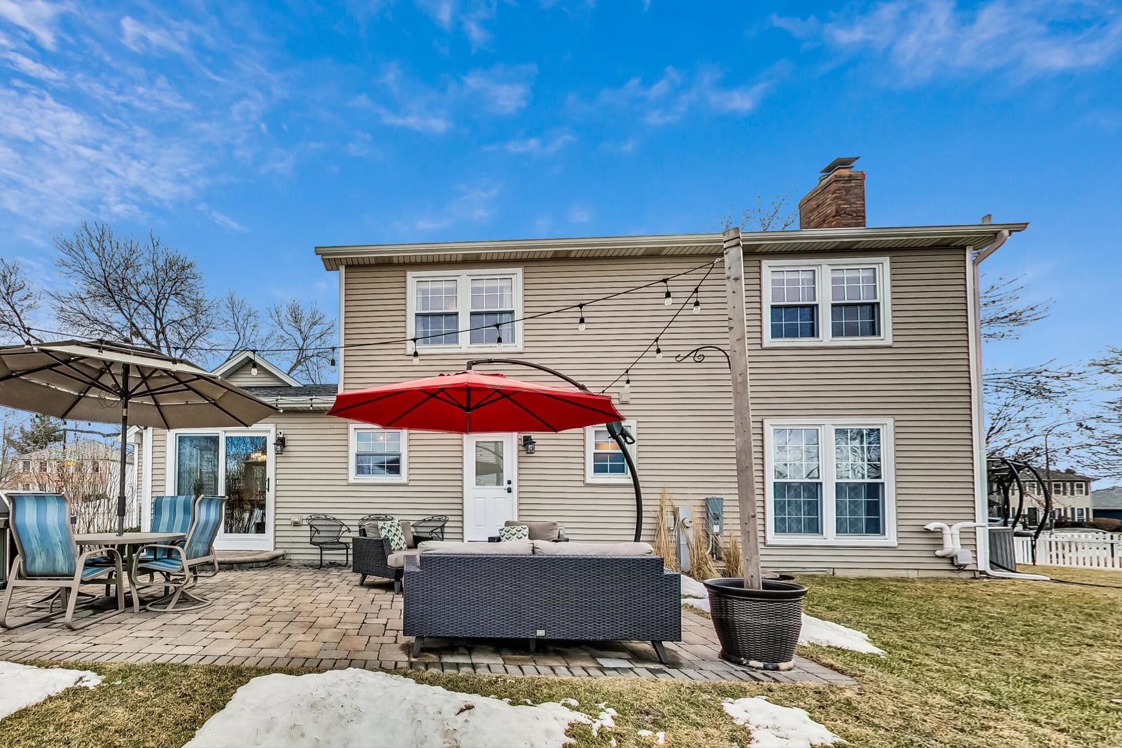 1345 East Bailey Road Naperville, IL 60565 - Photo 36 of 49 a patio with a table and chairs under an umbrella