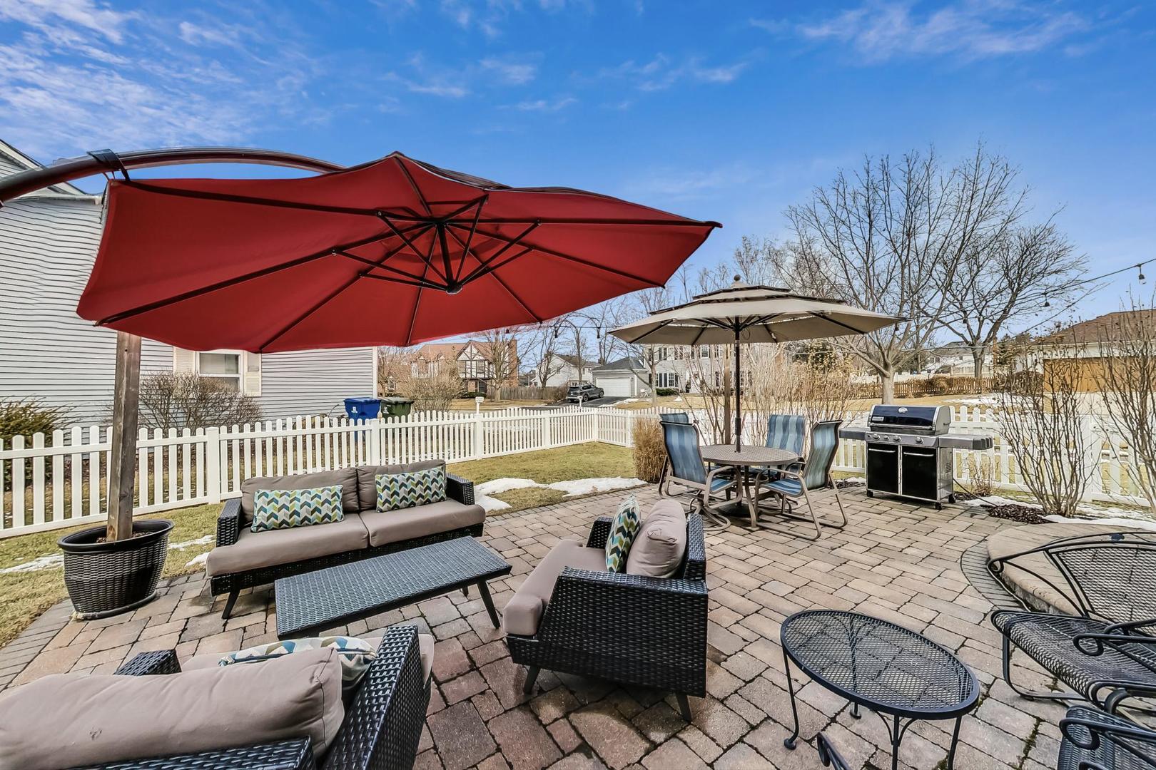 1345 East Bailey Road Naperville, IL 60565 - Photo 38 of 49 a view of a patio with couches chairs under an umbrella