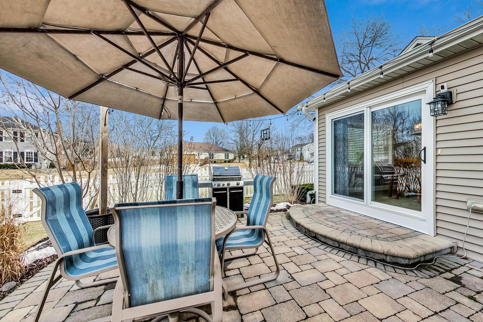 1345 East Bailey Road Naperville, IL 60565 - Photo 40 of 49 a view of a patio with table and chairs under an umbrella