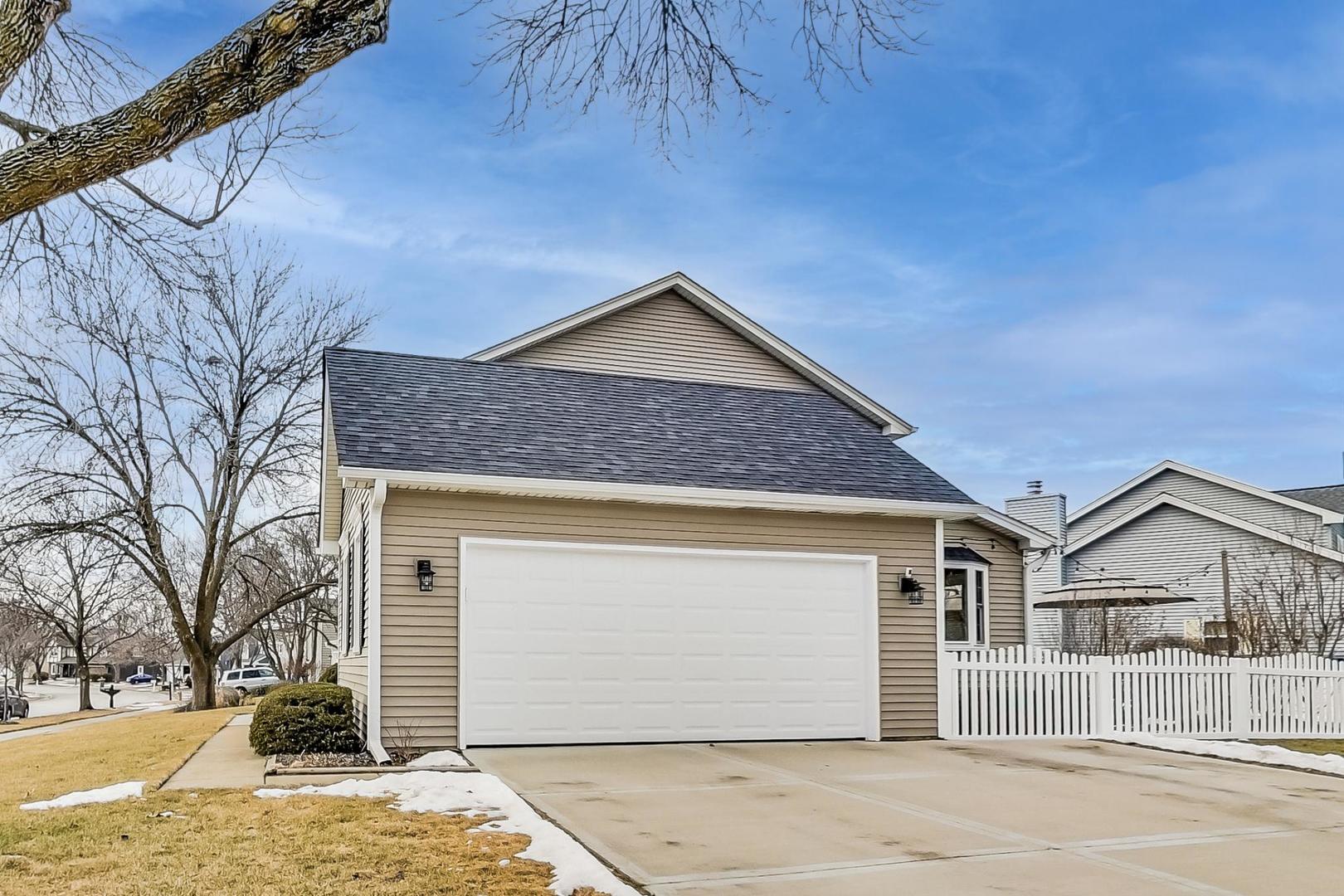 1345 East Bailey Road Naperville, IL 60565 - Photo 45 of 49 a front view of a house with a yard and garage