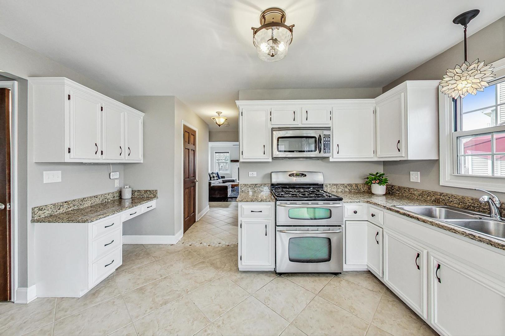 1345 East Bailey Road Naperville, IL 60565 - Photo 10 of 49 a kitchen with white cabinets and white appliances