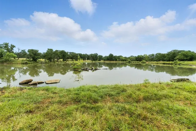 a view of a lake with houses in the back