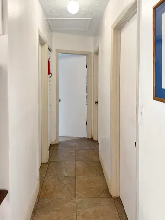 a view of a hallway with a door