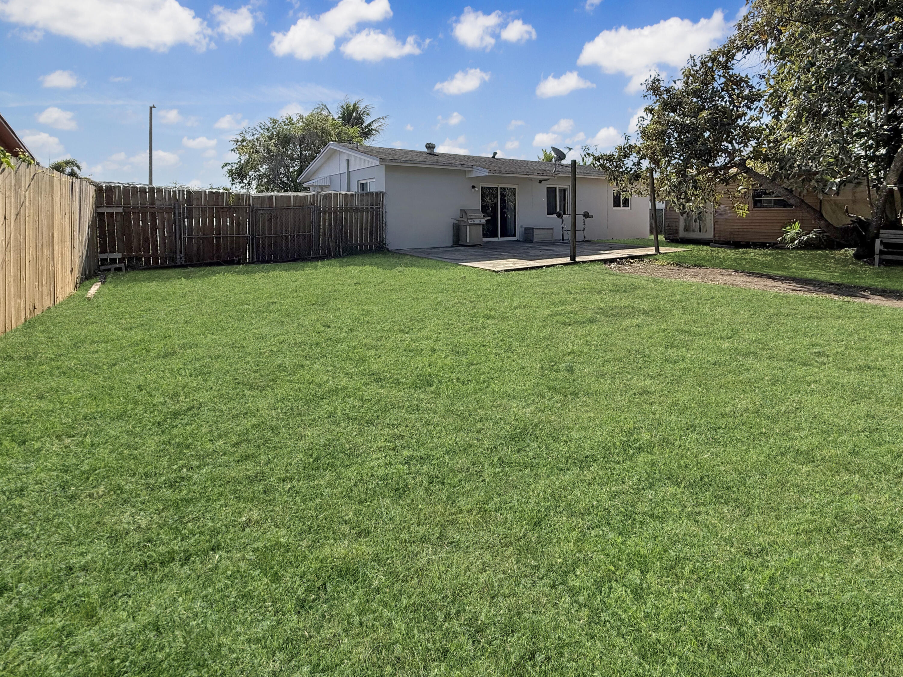 14314 Southwest 109th Court Miami, FL 33176 - Photo 15 of 15 a view of a house with a yard and large trees