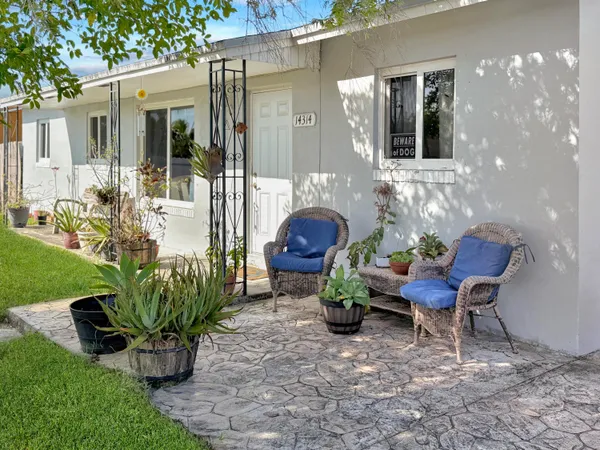 a house view with a seating space and garden space
