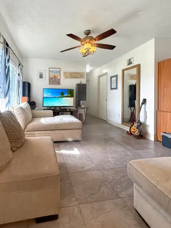 a living room with furniture a window and a chandelier