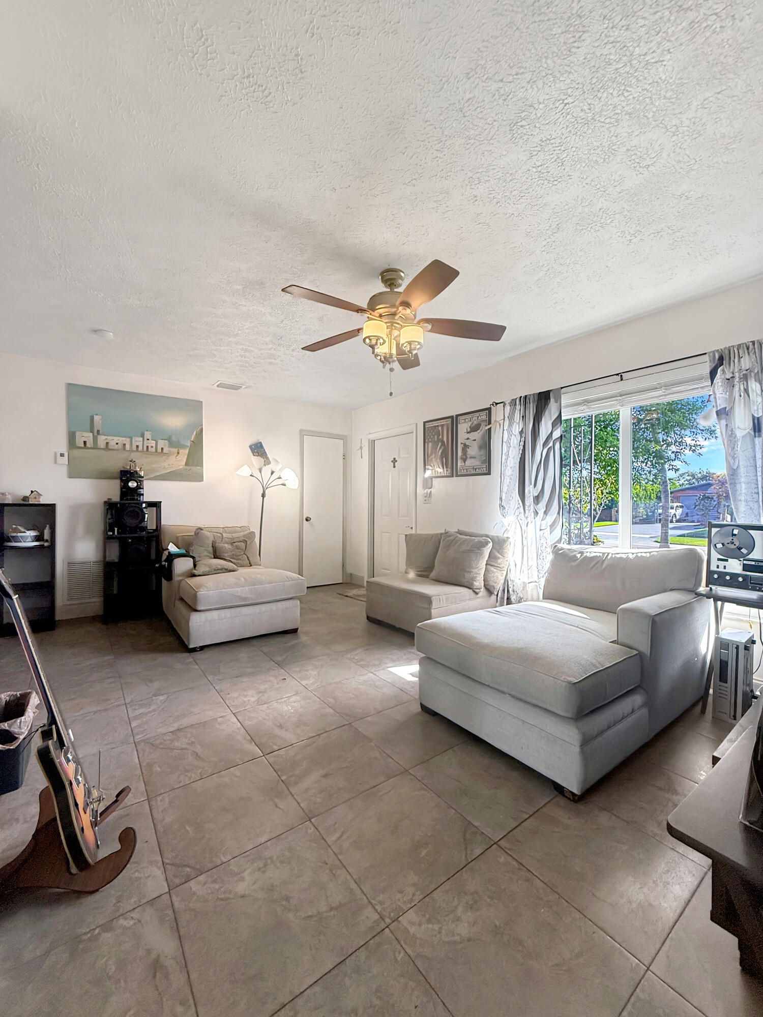 14314 Southwest 109th Court Miami, FL 33176 - Photo 5 of 15 a living room with furniture and a large window