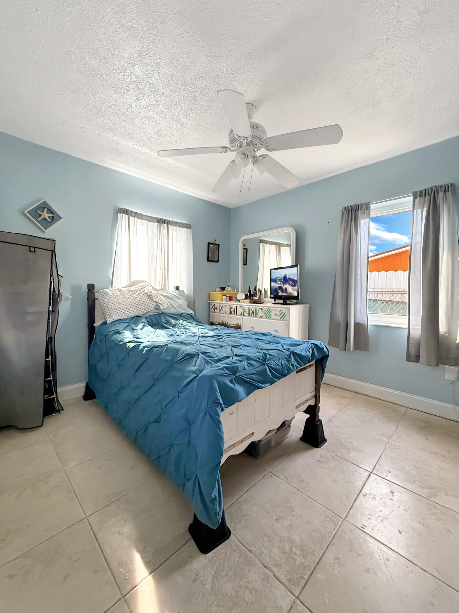 14314 Southwest 109th Court Miami, FL 33176 - Photo 8 of 15 a bedroom with a bed and a chandelier