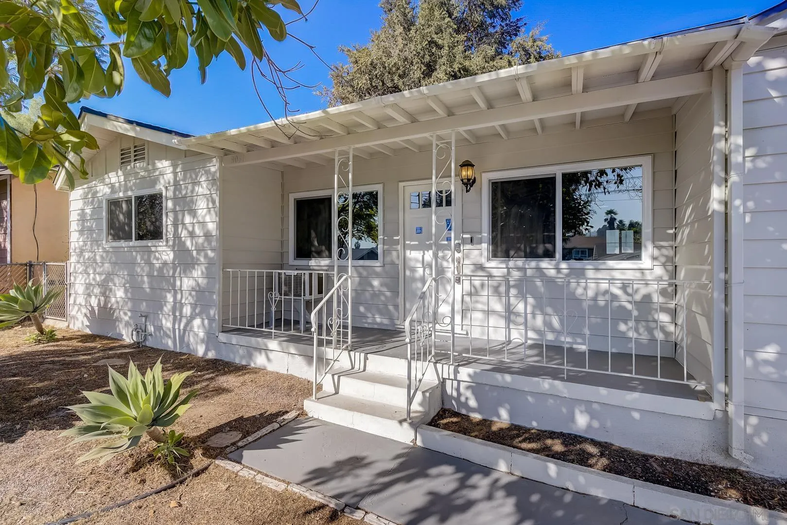 9060 Rosedale Drive Spring Valley, CA 91977 - Photo 14 of 28 a view of a patio with table and chairs potted plants with wooden floor and fence