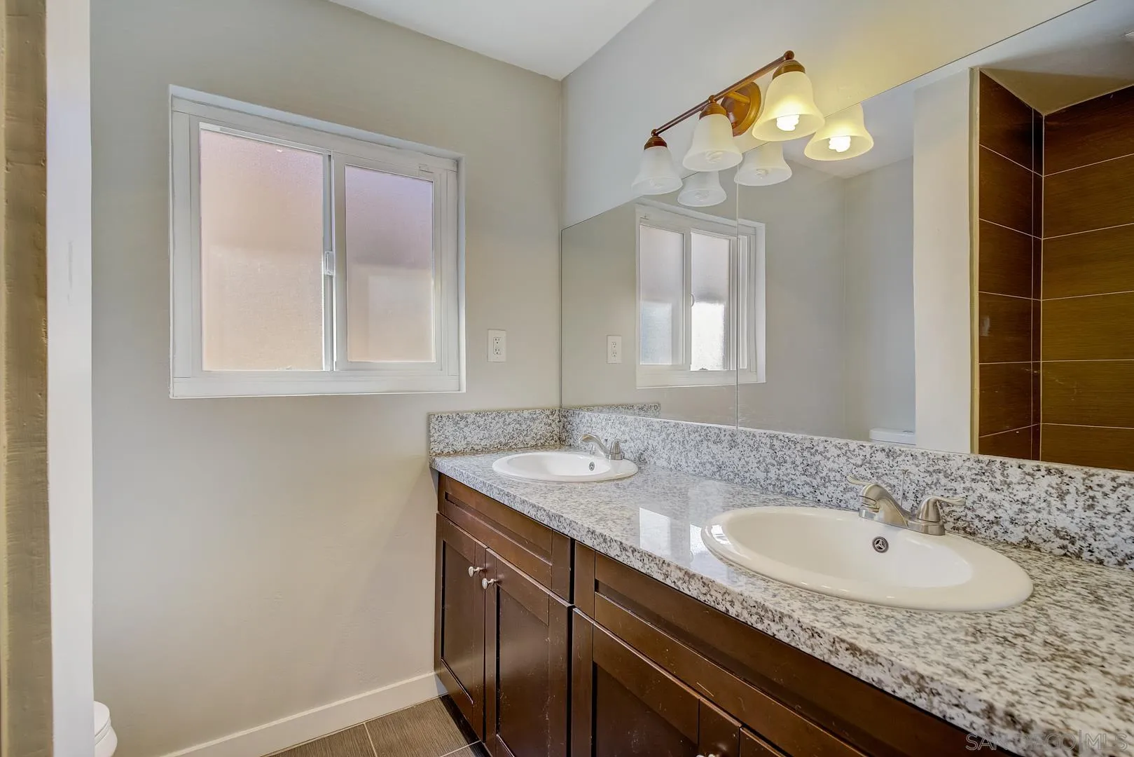 9060 Rosedale Drive Spring Valley, CA 91977 - Photo 23 of 28 a bathroom with a sink a vanity and a mirror