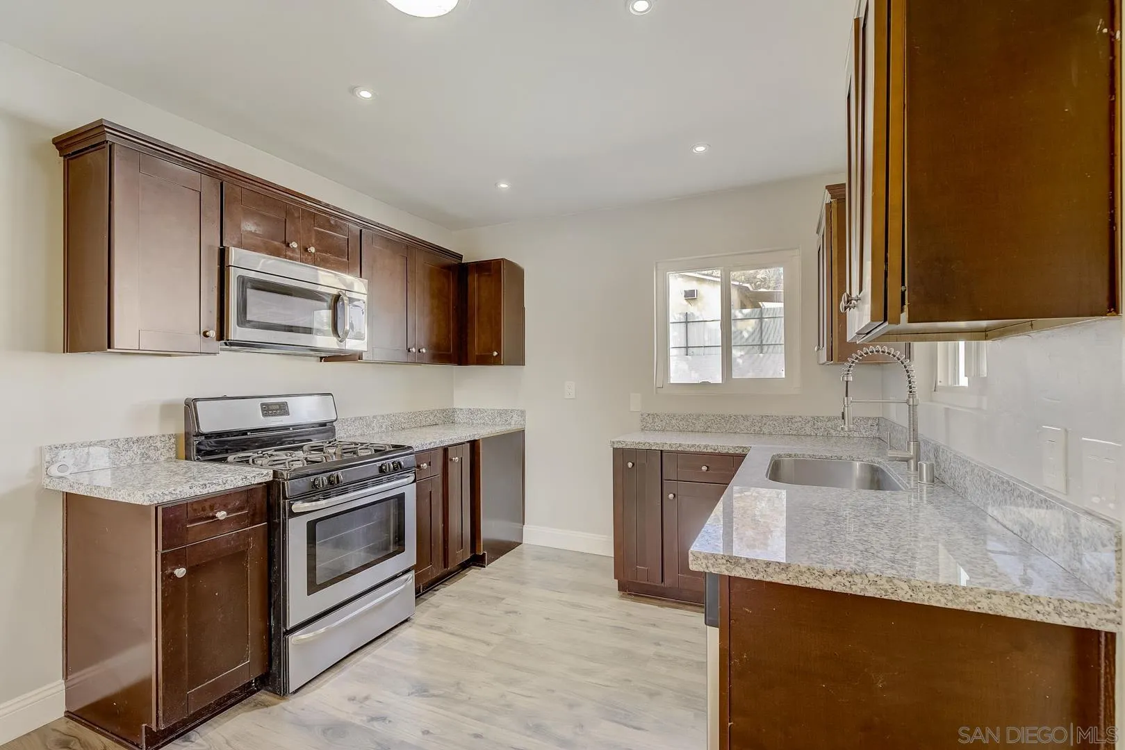 9060 Rosedale Drive Spring Valley, CA 91977 - Photo 4 of 28 a kitchen with granite countertop stainless steel appliances a stove sink and microwave