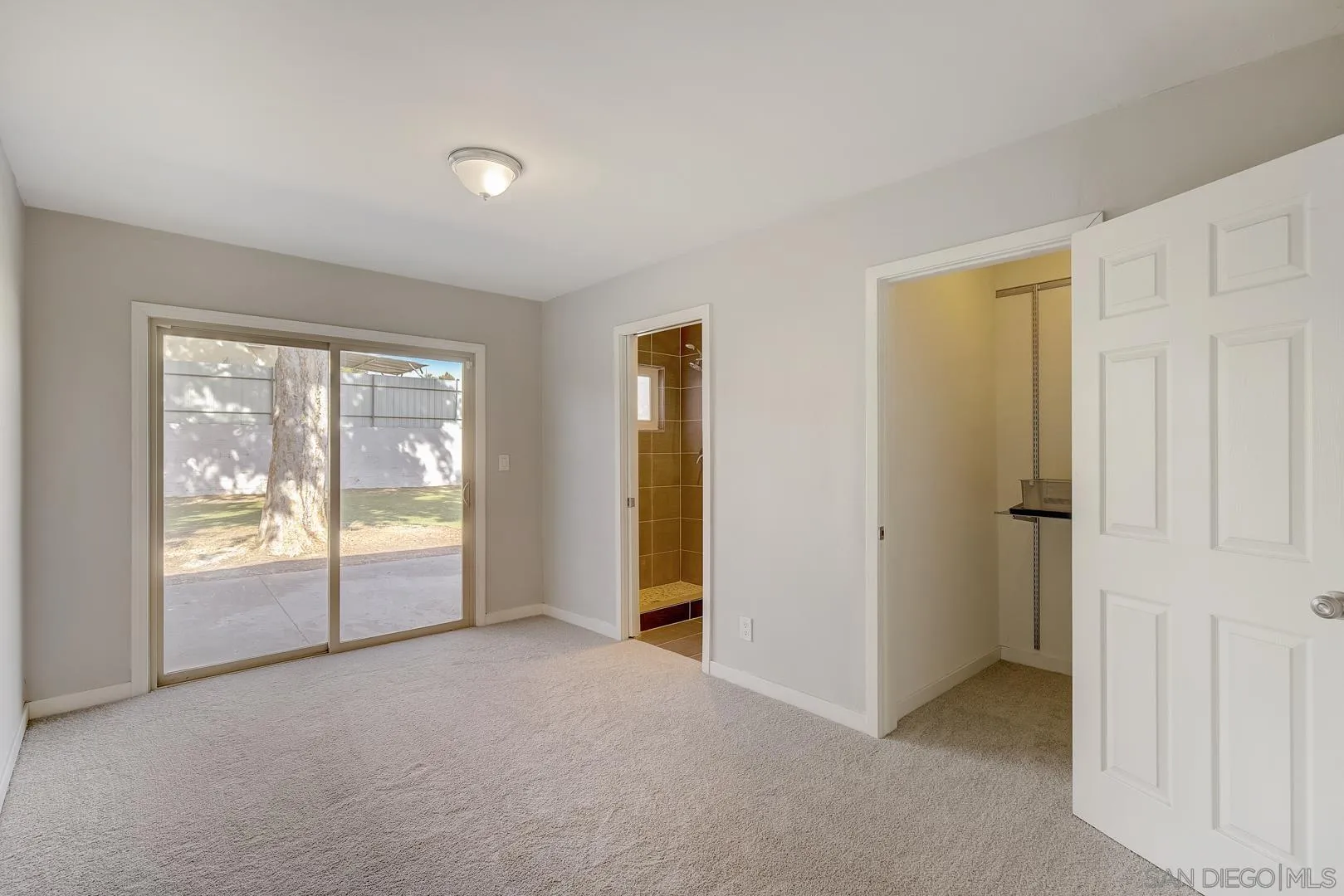 9060 Rosedale Drive Spring Valley, CA 91977 - Photo 7 of 28 an empty room with sliding glass door and shower