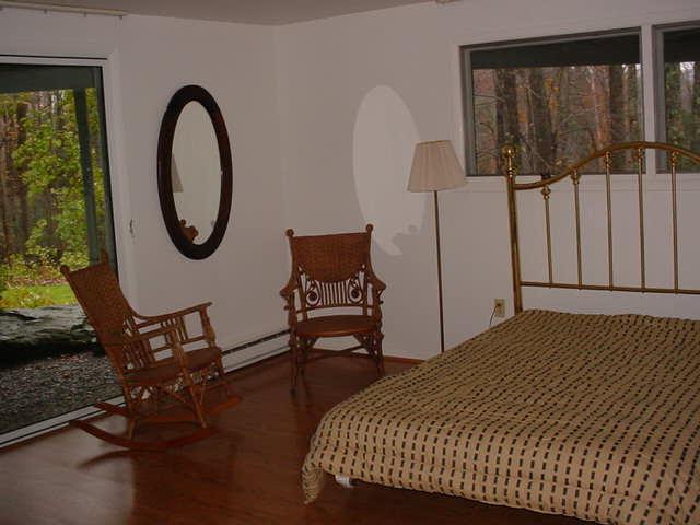 14 Averic Road Stockbridge, MA 01266 - Photo 14 of 16 a bedroom with a bed a dresser and a window