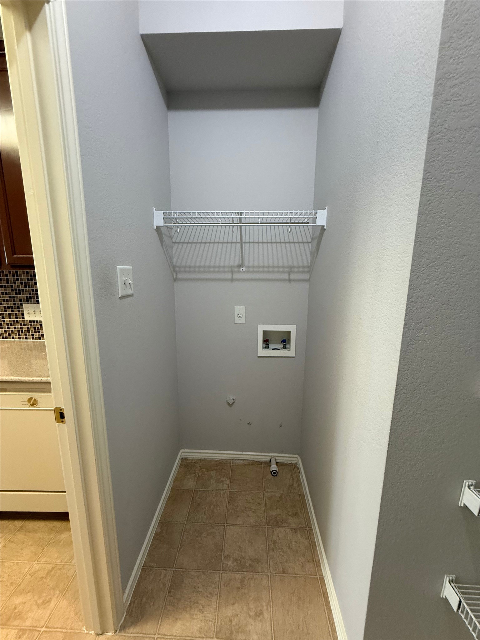 1900 Scofield Ridge Parkway, Unit 4701 Austin, TX 78727 - Photo 13 of 27 A well-appointed laundry nook with convenient shelving offers utility and style.