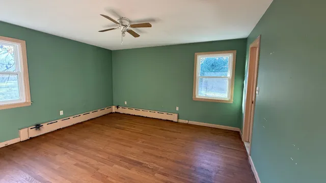 a view of a room with window and wooden floor