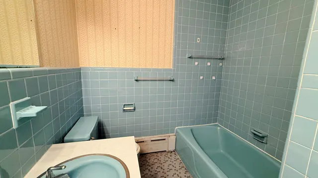 a bathroom with a sink a bathtub and window