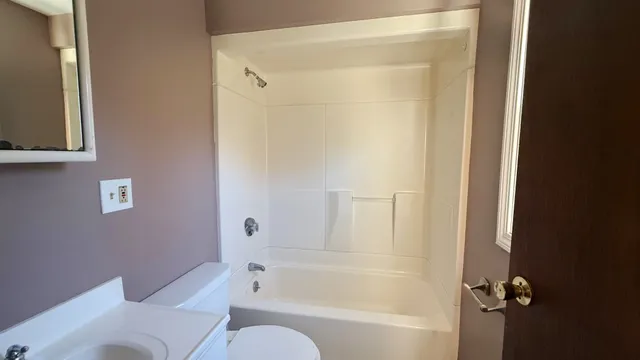 a bathroom with a bathtub and a toilet