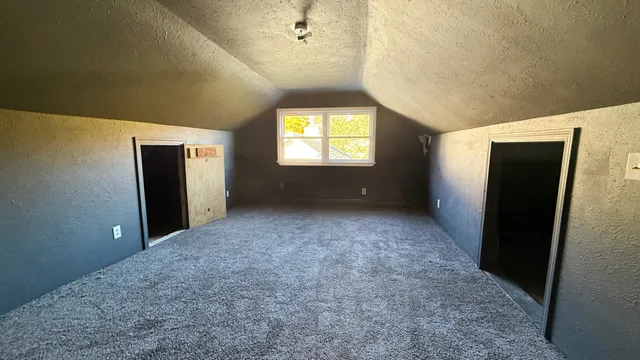 an empty room with windows and closet
