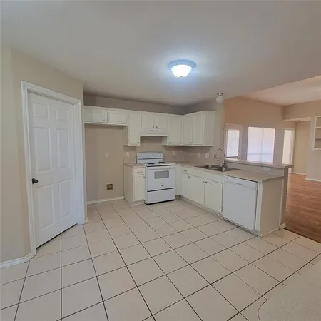 a kitchen with granite countertop cabinets and white stainless steel appliances