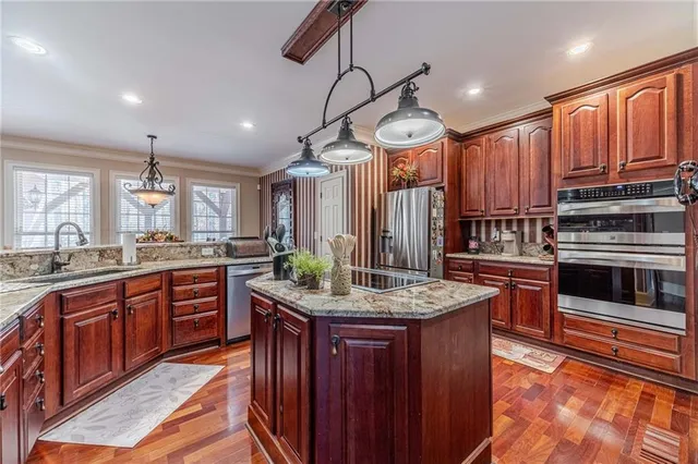 a bathroom with a granite countertop sink a large mirror and a bathtub next to a window