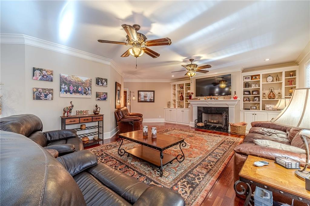 686 Newton Factory Bridge Road Covington, GA 30014 - Photo 18 of 110 a living room with furniture a fireplace and a flat screen tv