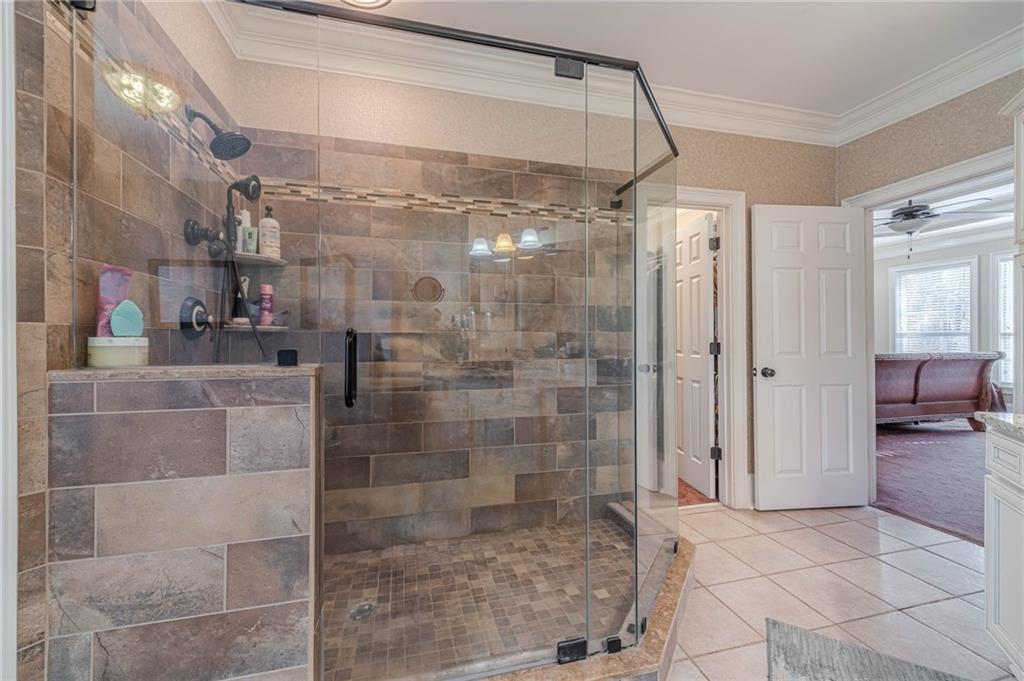 686 Newton Factory Bridge Road Covington, GA 30014 - Photo 33 of 110 a bathroom with a glass shower door
