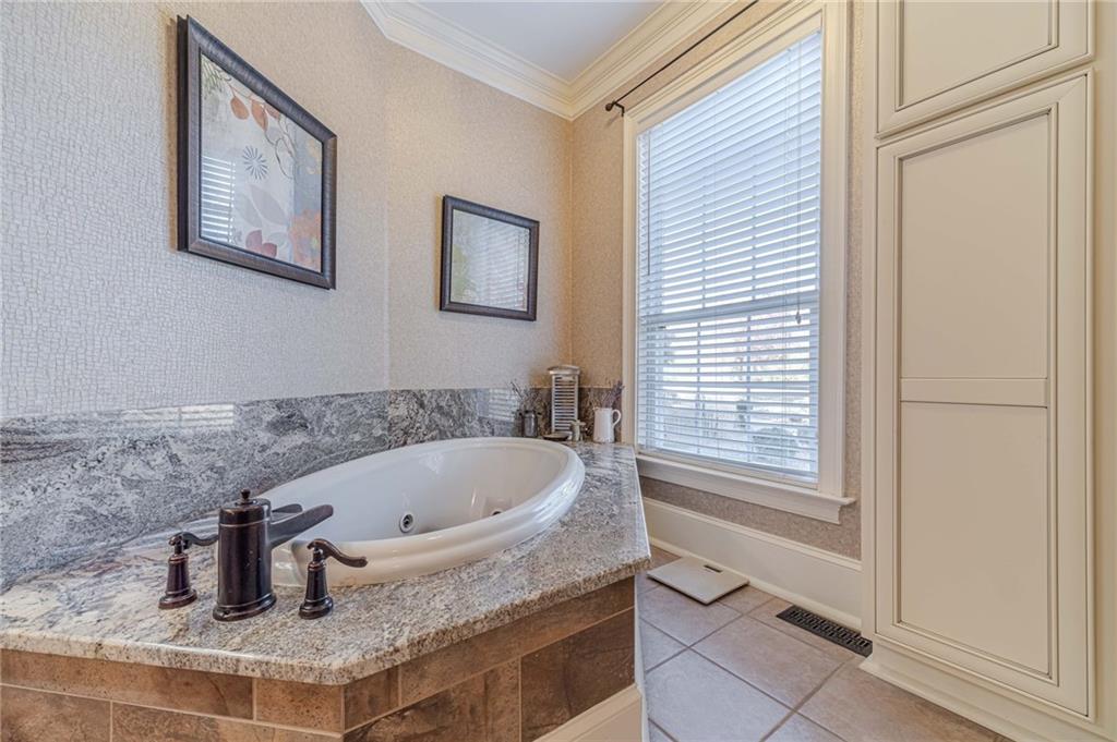 686 Newton Factory Bridge Road Covington, GA 30014 - Photo 34 of 110 a bathroom with a granite countertop sink and a mirror