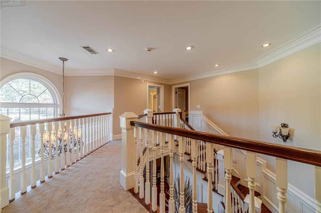 686 Newton Factory Bridge Road Covington, GA 30014 - Photo 38 of 110 a view of a hallway with wooden floor and stairs
