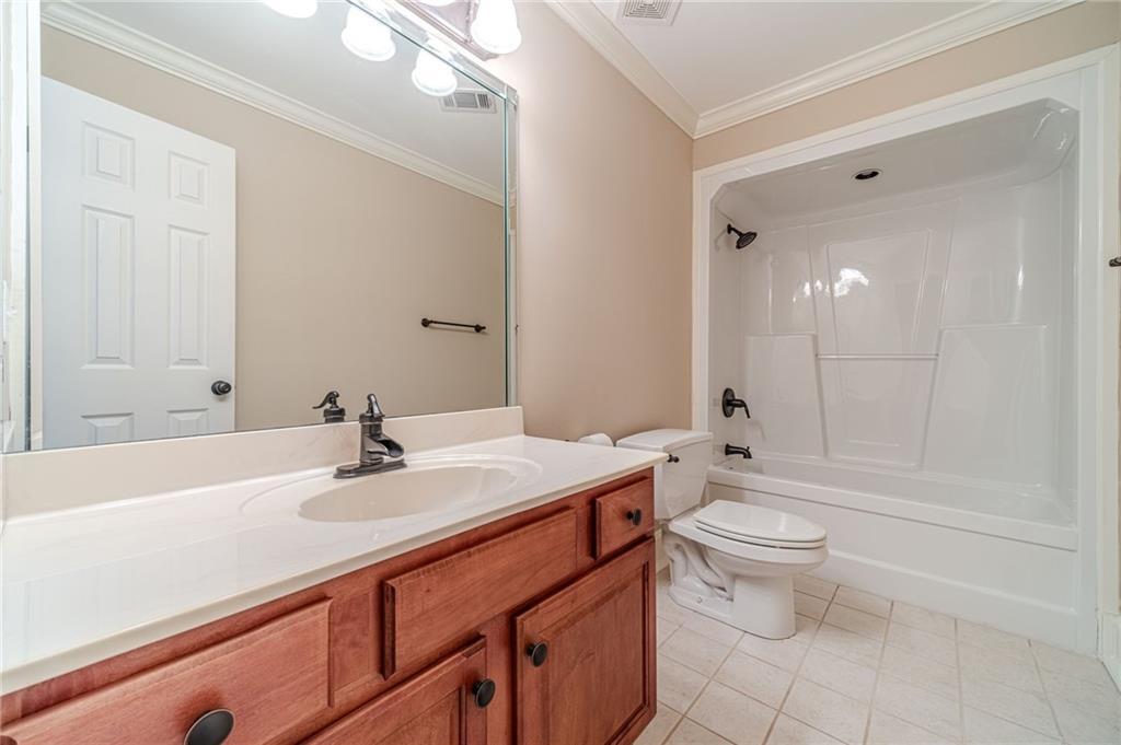 686 Newton Factory Bridge Road Covington, GA 30014 - Photo 40 of 110 a bathroom with a sink a toilet and shower