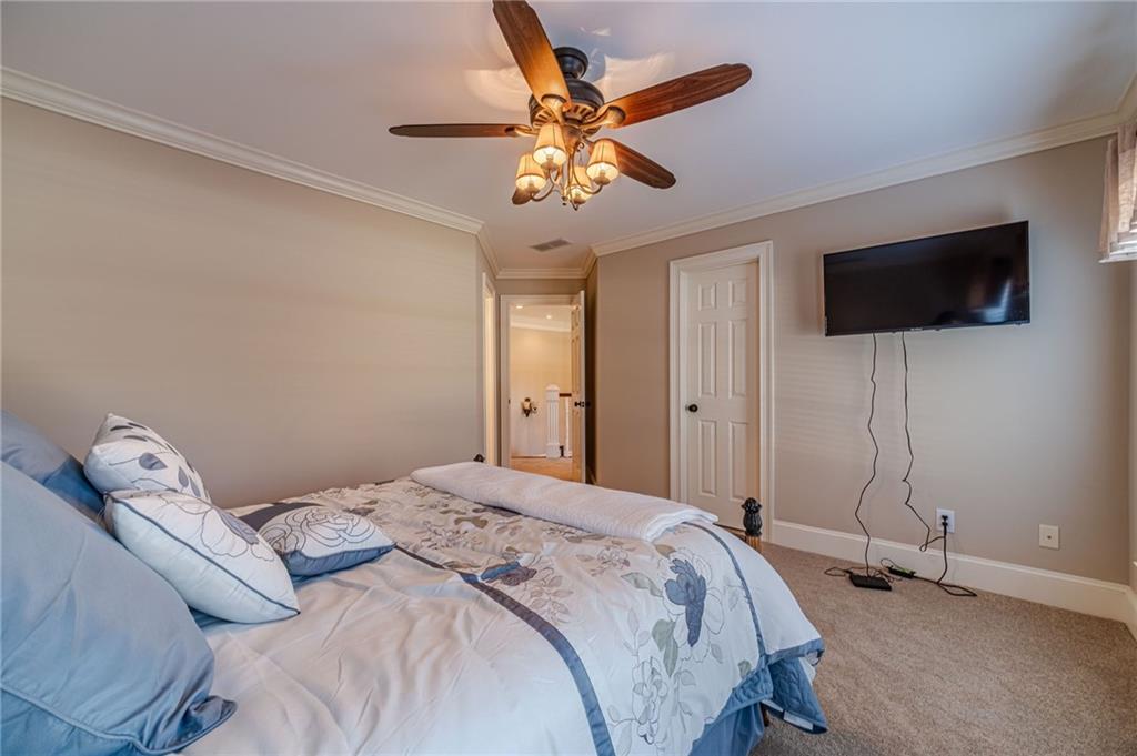 686 Newton Factory Bridge Road Covington, GA 30014 - Photo 43 of 110 a bedroom with a bed and a flat screen tv