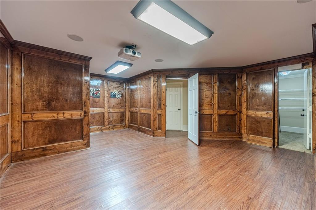 686 Newton Factory Bridge Road Covington, GA 30014 - Photo 50 of 110 an empty room with wooden floor and way to kitchen