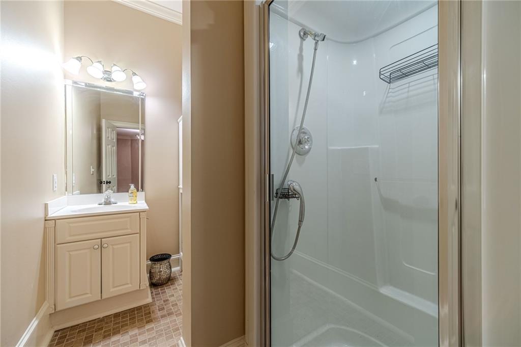 686 Newton Factory Bridge Road Covington, GA 30014 - Photo 51 of 110 a bathroom with a granite countertop shower a mirror and a sink