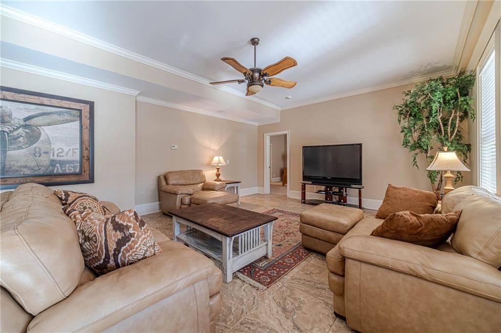 686 Newton Factory Bridge Road Covington, GA 30014 - Photo 55 of 110 a living room with furniture a flat screen tv and a potted plant