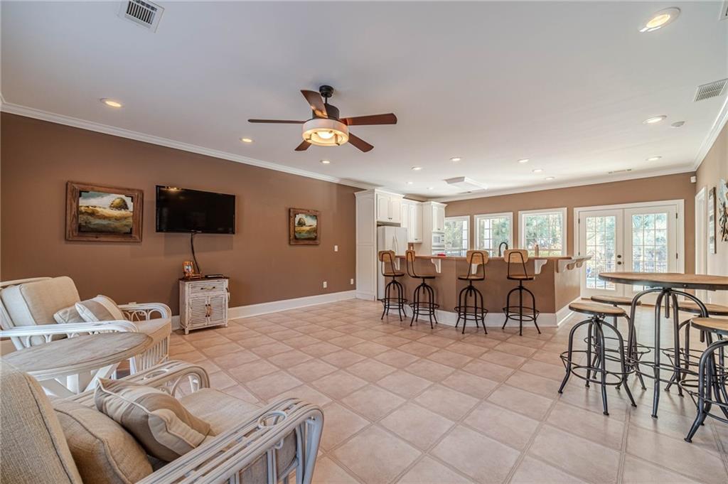 686 Newton Factory Bridge Road Covington, GA 30014 - Photo 64 of 110 a living room with furniture and a flat screen tv