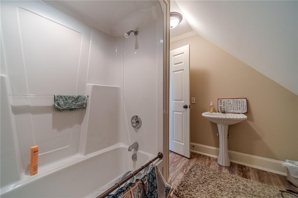 686 Newton Factory Bridge Road Covington, GA 30014 - Photo 84 of 110 a bathroom with a bathtub and a shower