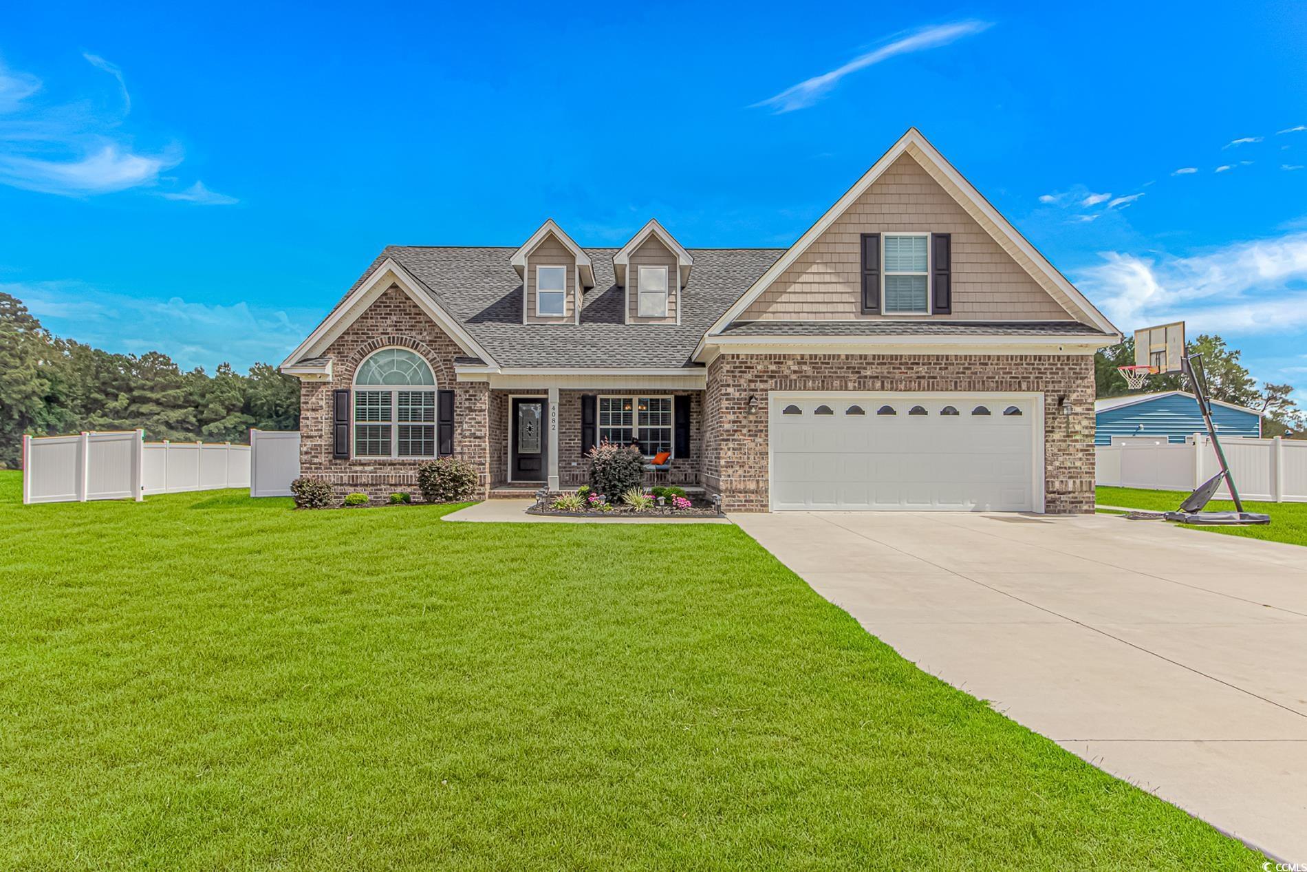 View of front facade with a shingled roof, covered porch, concrete driveway, brick siding, and a garage