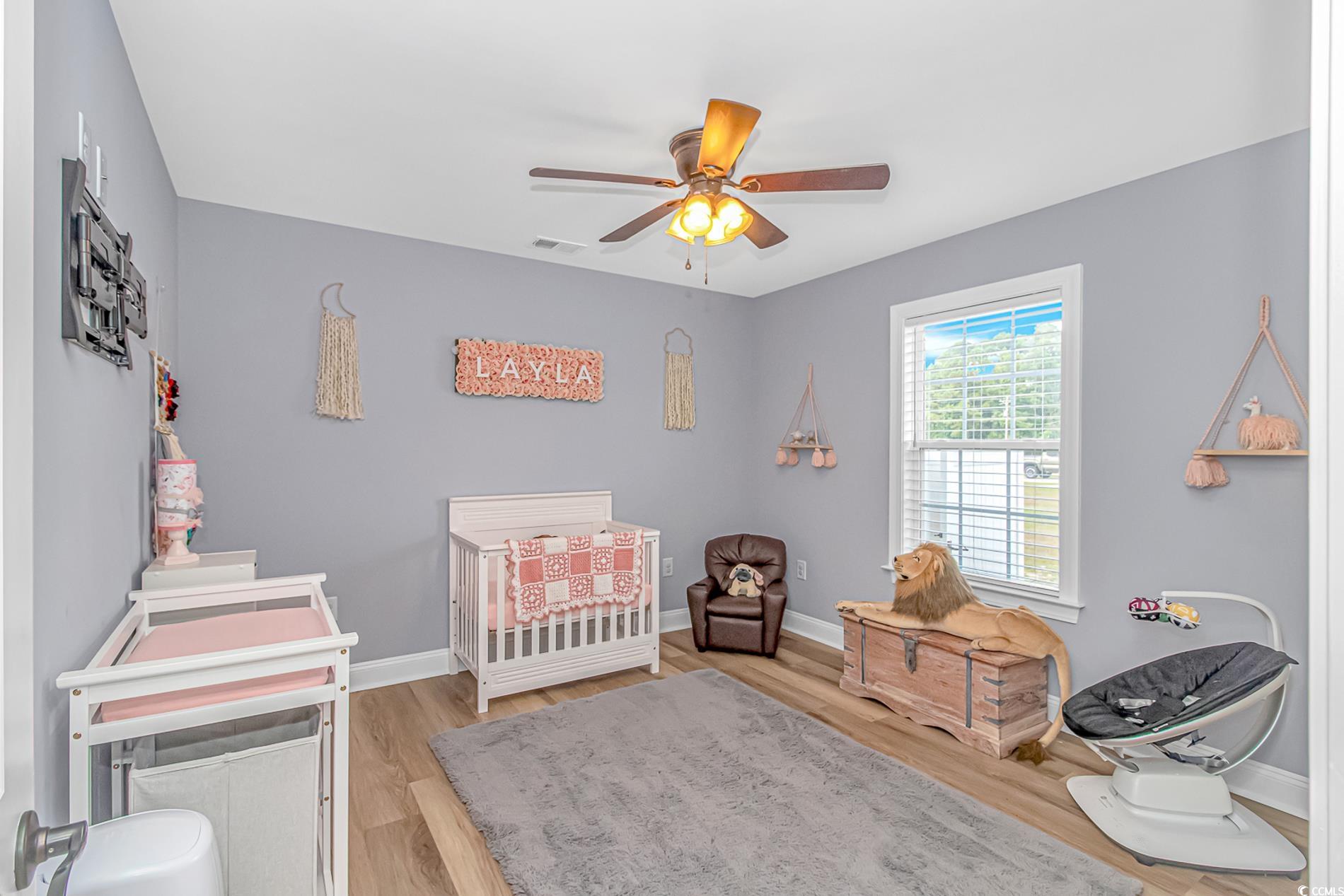 4082 Edwards Road Aynor, SC 29511 - Photo 15 of 40 Bedroom featuring a nursery area, light wood-style flooring, and ceiling fan