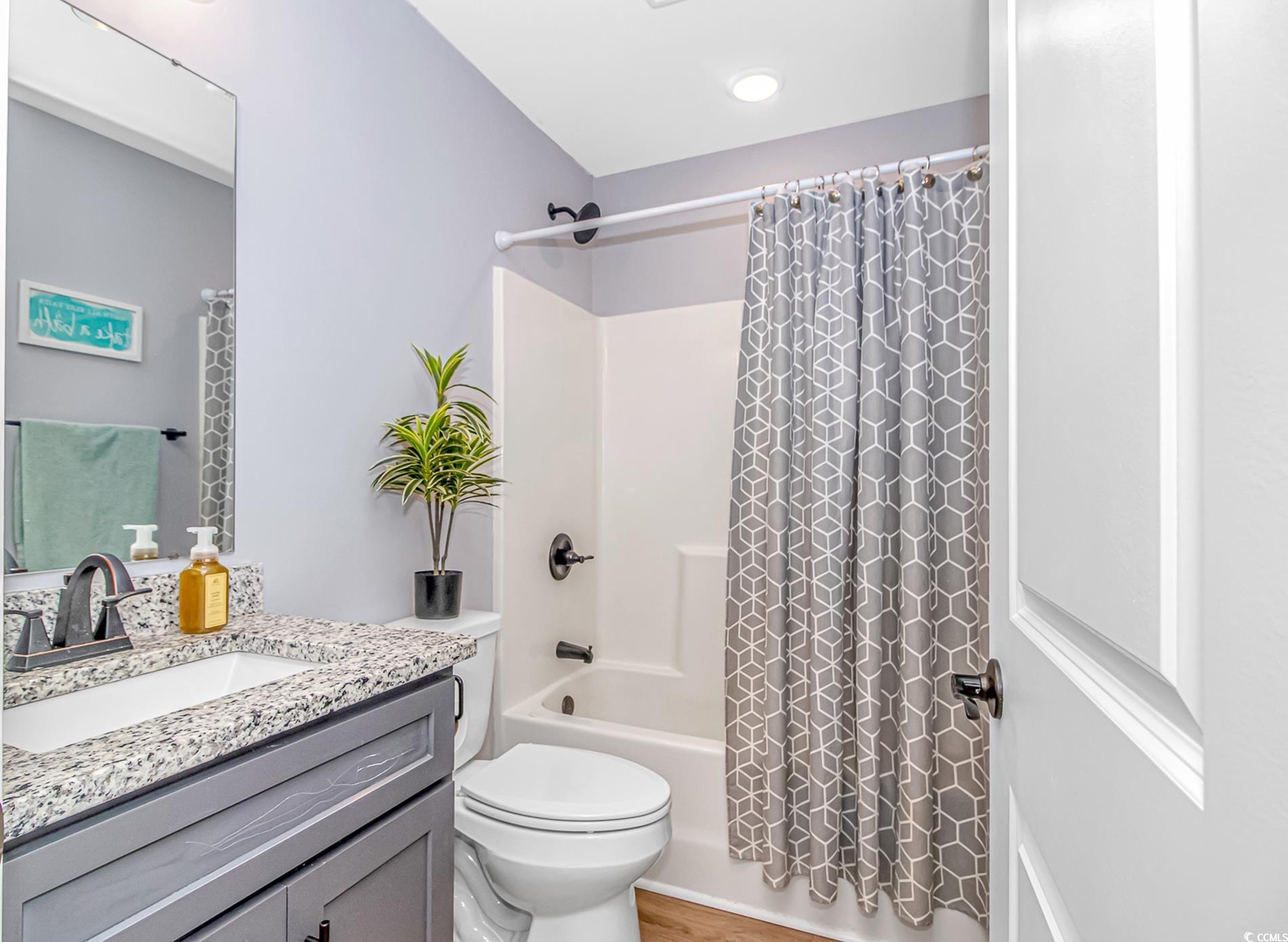 4082 Edwards Road Aynor, SC 29511 - Photo 17 of 40 Bathroom featuring shower / bath combination with curtain, vanity, and light wood-style floors