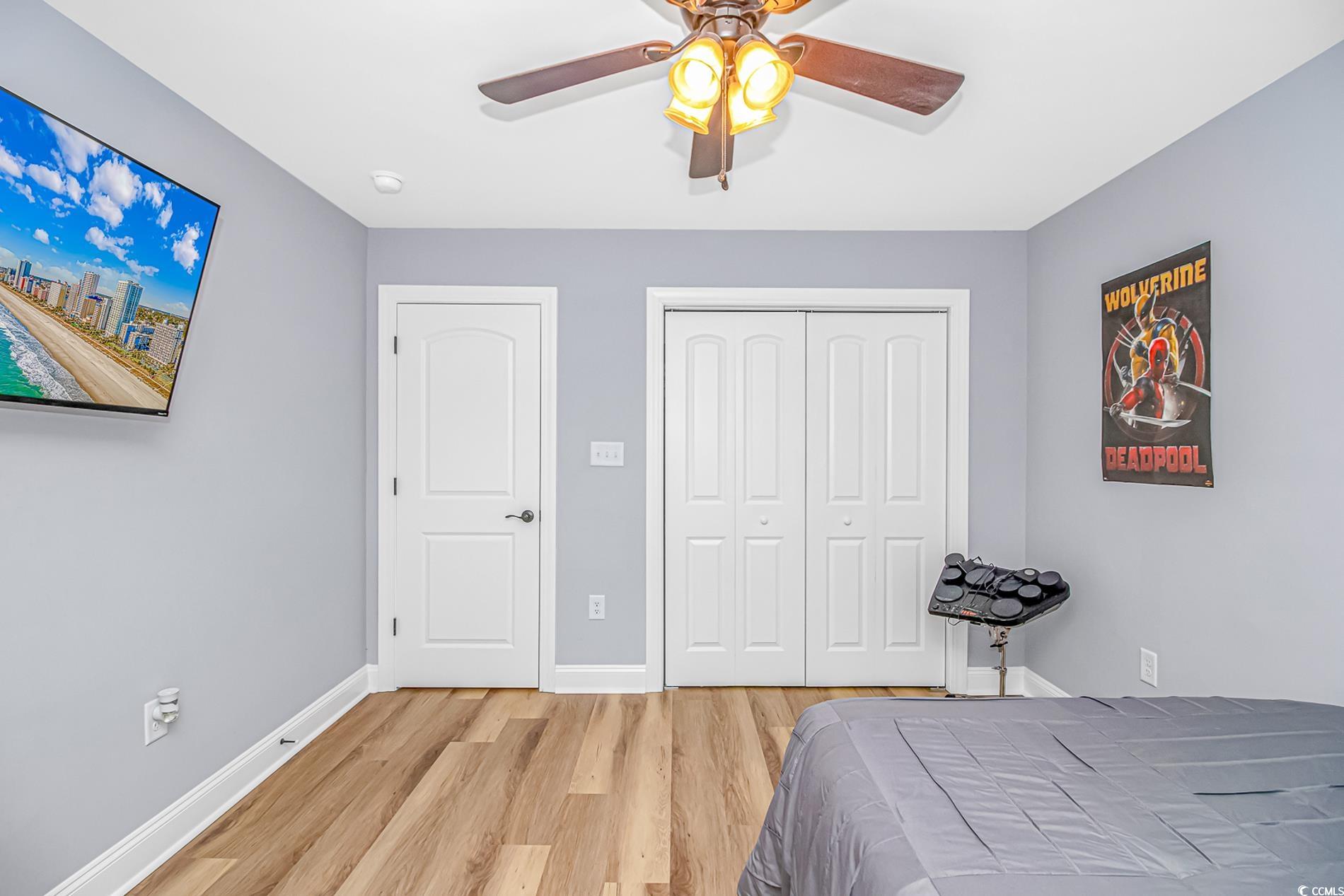4082 Edwards Road Aynor, SC 29511 - Photo 19 of 40 Bedroom with light wood-style floors, a closet, and a ceiling fan
