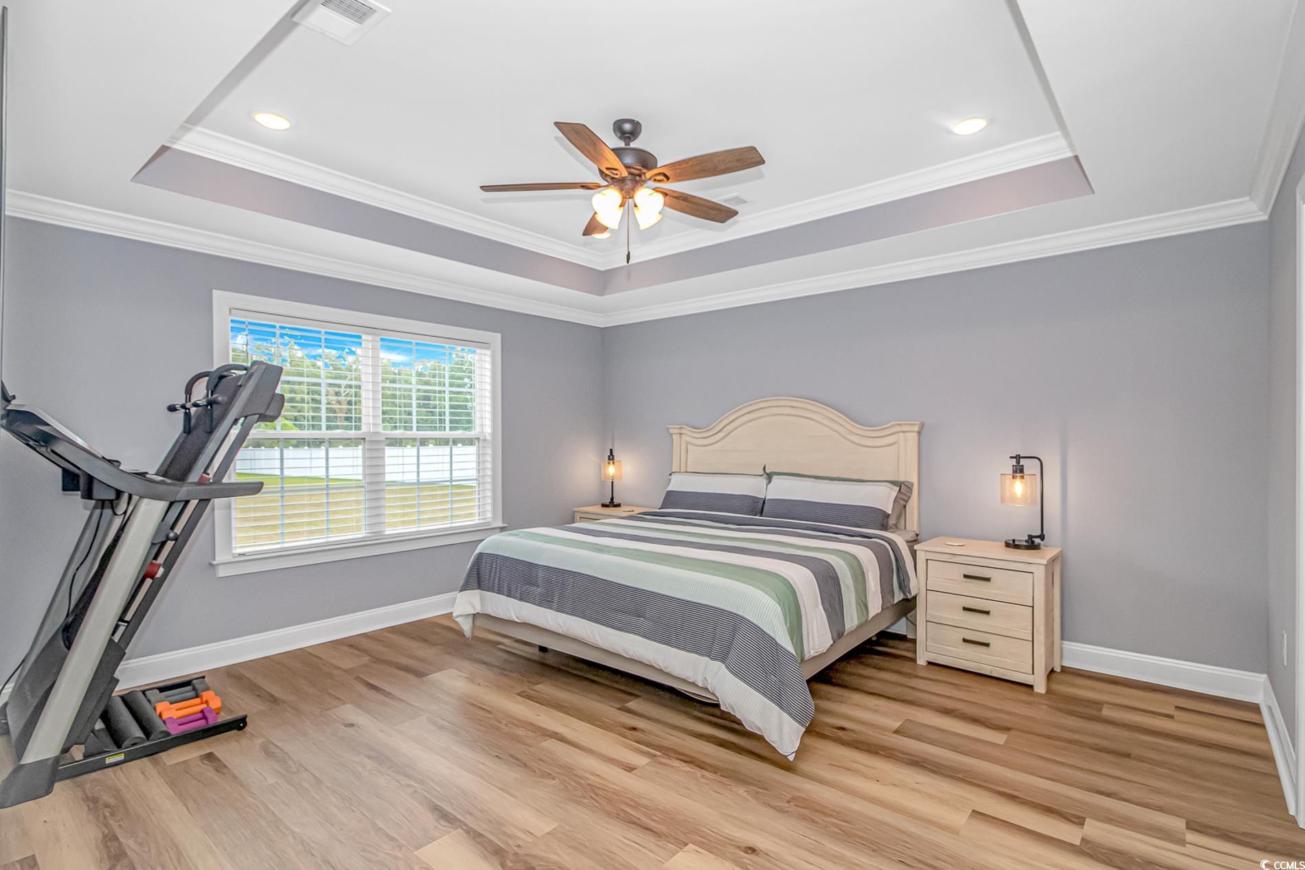 4082 Edwards Road Aynor, SC 29511 - Photo 20 of 40 Bedroom featuring a raised ceiling, light wood-style flooring, crown molding, a ceiling fan, and recessed lighting