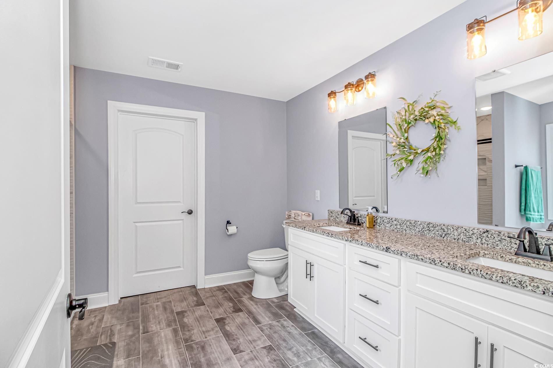 4082 Edwards Road Aynor, SC 29511 - Photo 22 of 40 Full bath with double vanity and wood tiled floors
