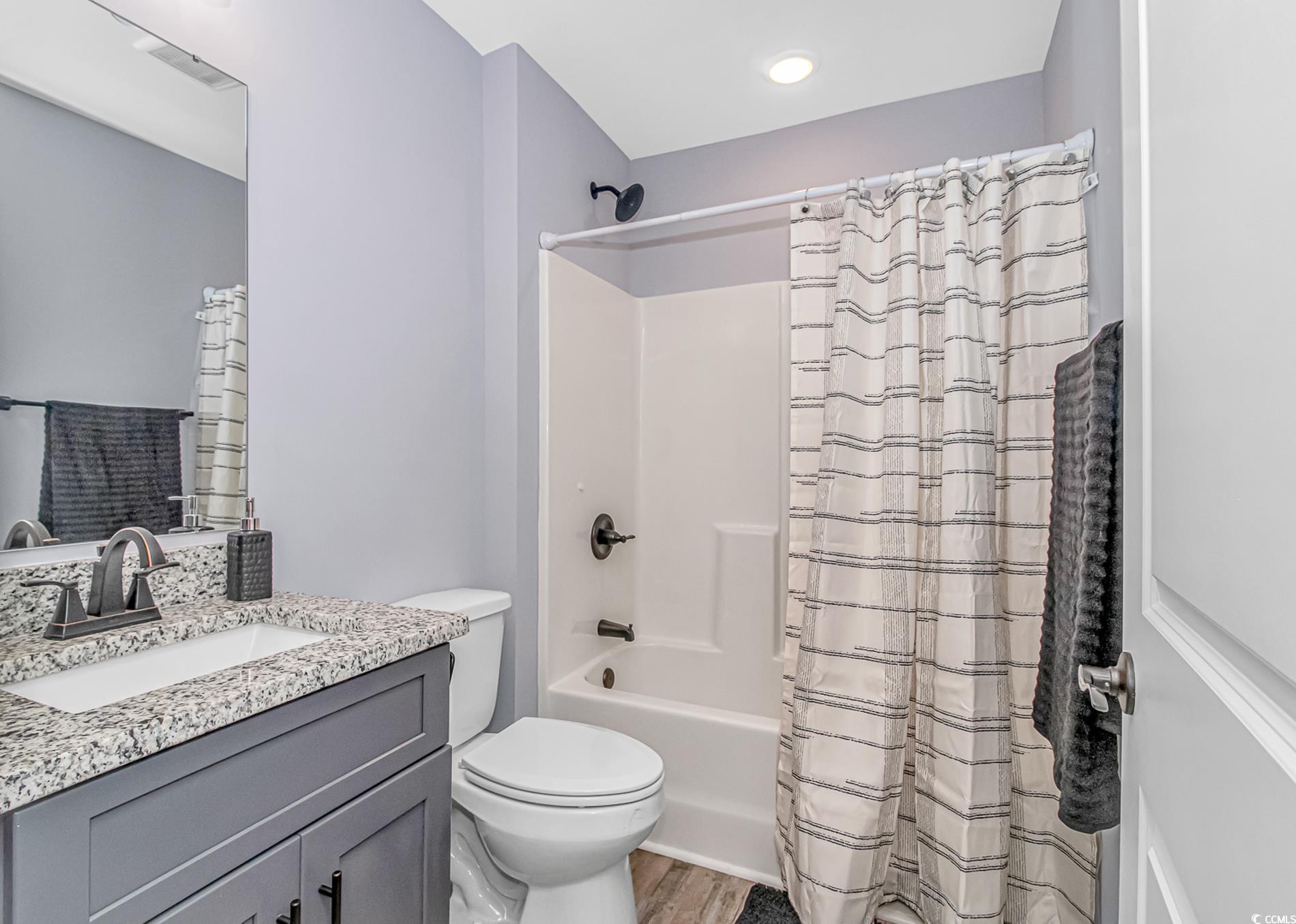 4082 Edwards Road Aynor, SC 29511 - Photo 28 of 40 Full bathroom with shower / bath combo with shower curtain, vanity, and light wood-type flooring