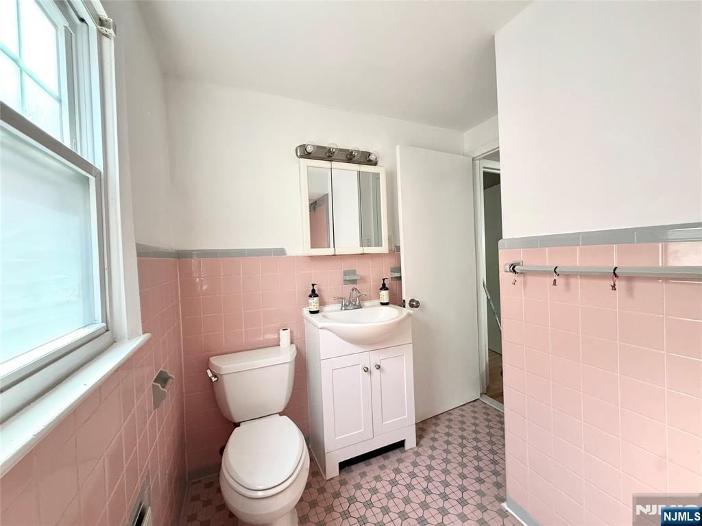 175 Van Winkle Street, Unit 2 East Rutherford, NJ 07073 - Photo 20 of 20 a bathroom with a toilet a sink and a window