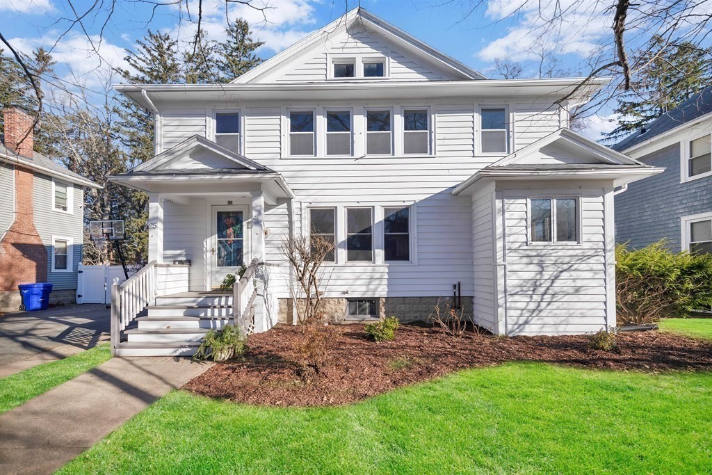 25 Daviston Street Springfield, MA 01108 - Photo 1 of 42 a front view of a house with a garden and plants