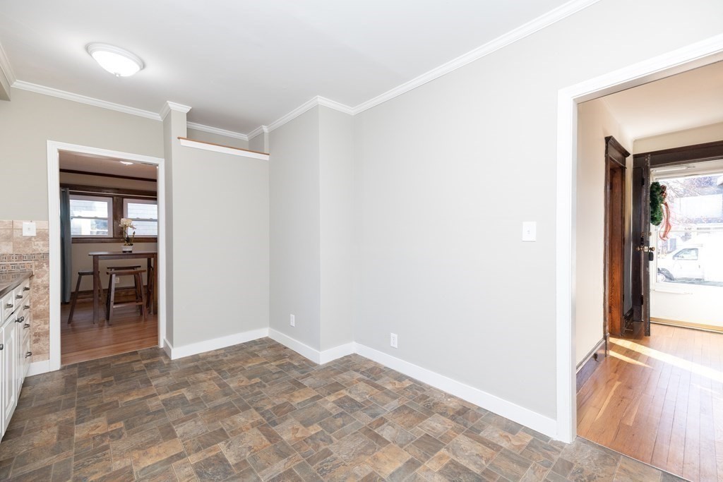 25 Daviston Street Springfield, MA 01108 - Photo 18 of 42 an empty room with kitchen view and a window