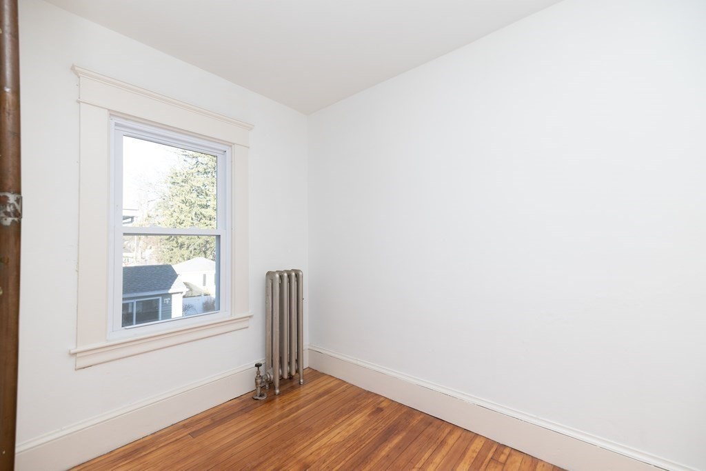 25 Daviston Street Springfield, MA 01108 - Photo 20 of 42 a view of an empty room with wooden floor and a window